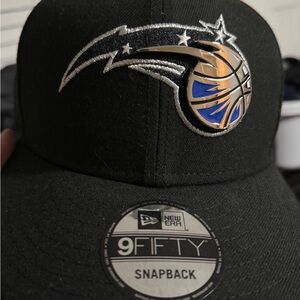 New Era Orlando Magic Snapback Hat with Blue and Silver metal logo.
